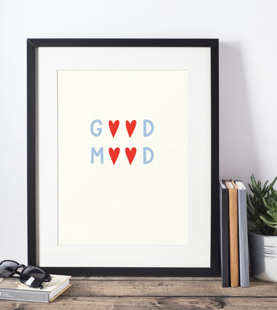 mockup-of-a-picture-frame-standing-on-a-wooden-table-and-against-a-white-wall-600-el (1).png