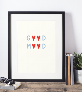 mockup-of-a-picture-frame-standing-on-a-wooden-table-and-against-a-white-wall-600-el (1).png